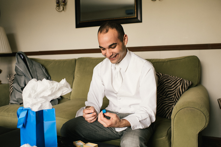 groom with Lego cufflinks before wedding