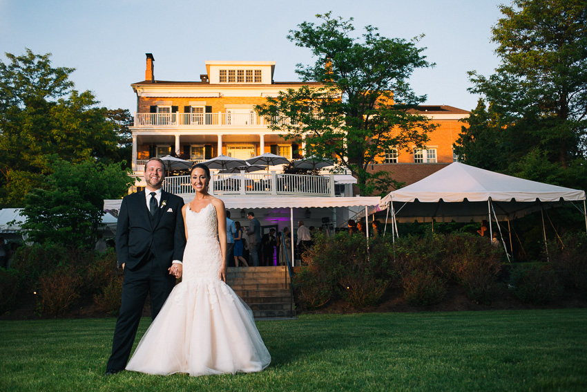 bride and groom portrait in front of Aurora Inn wedding reception