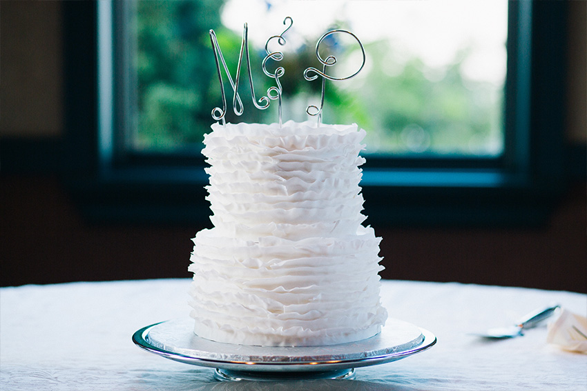 clean white ruffled wedding cake