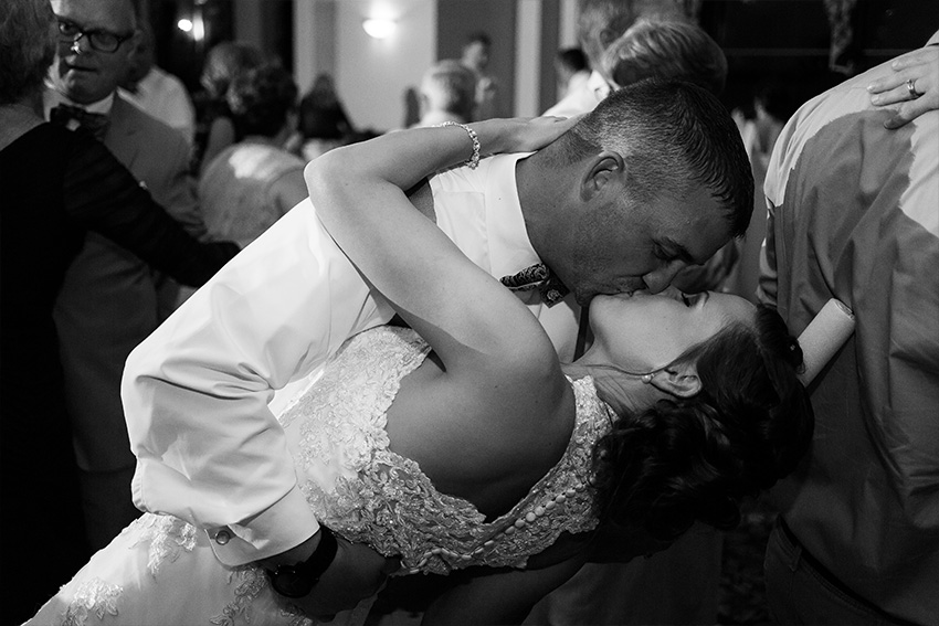 groom dips bride at belhurst wedding reception