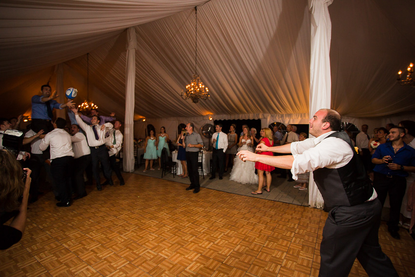 groom throws rugby ball with garter on it