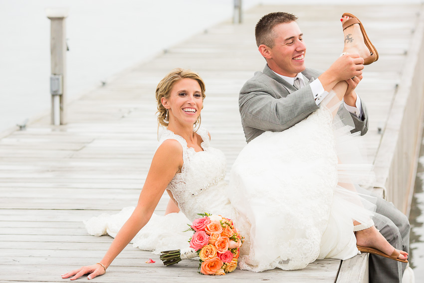 groom helping bride get her shoe on