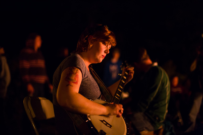 groom's sister playing banjo by the fire