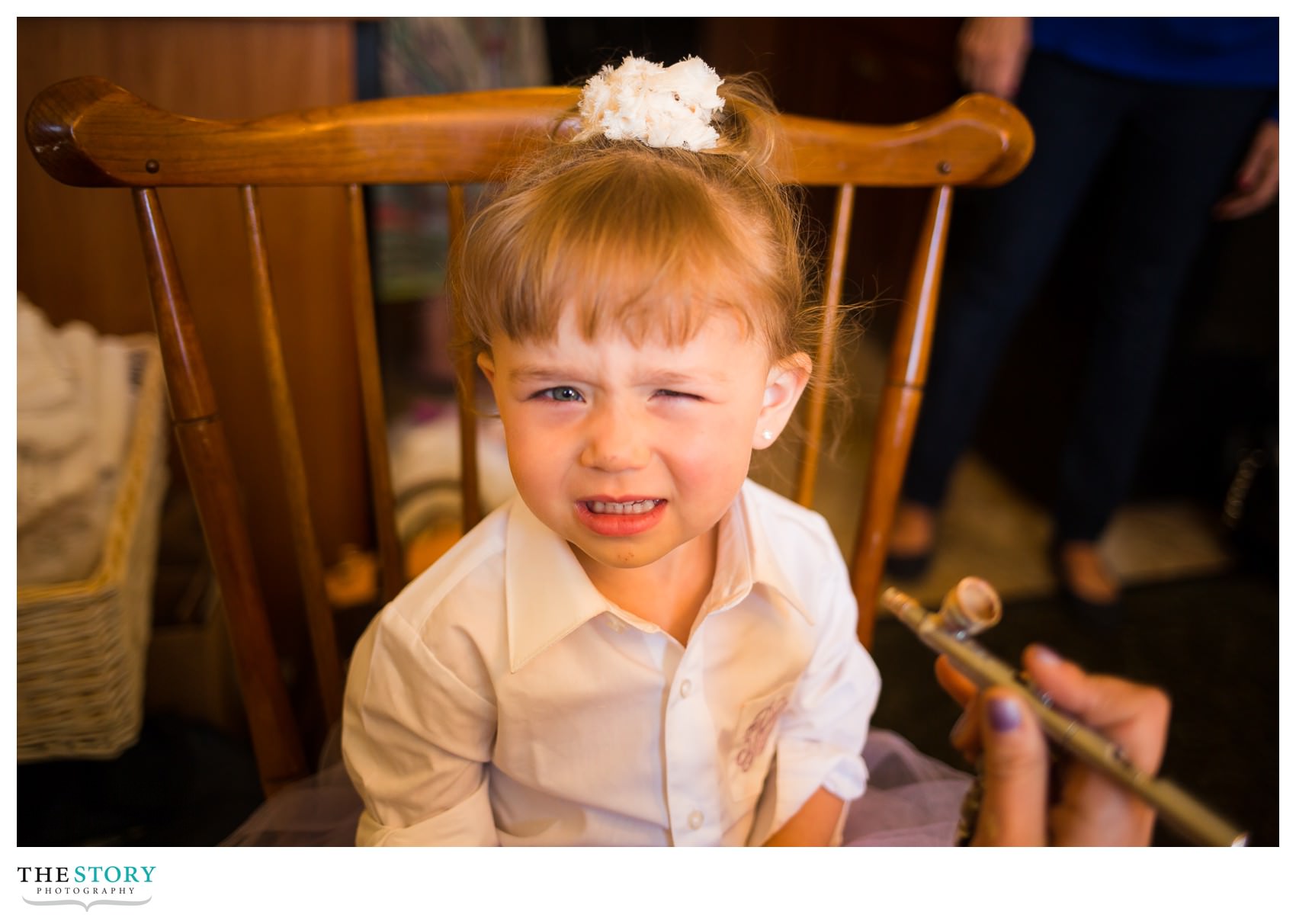 flower girl getting air brush makeup