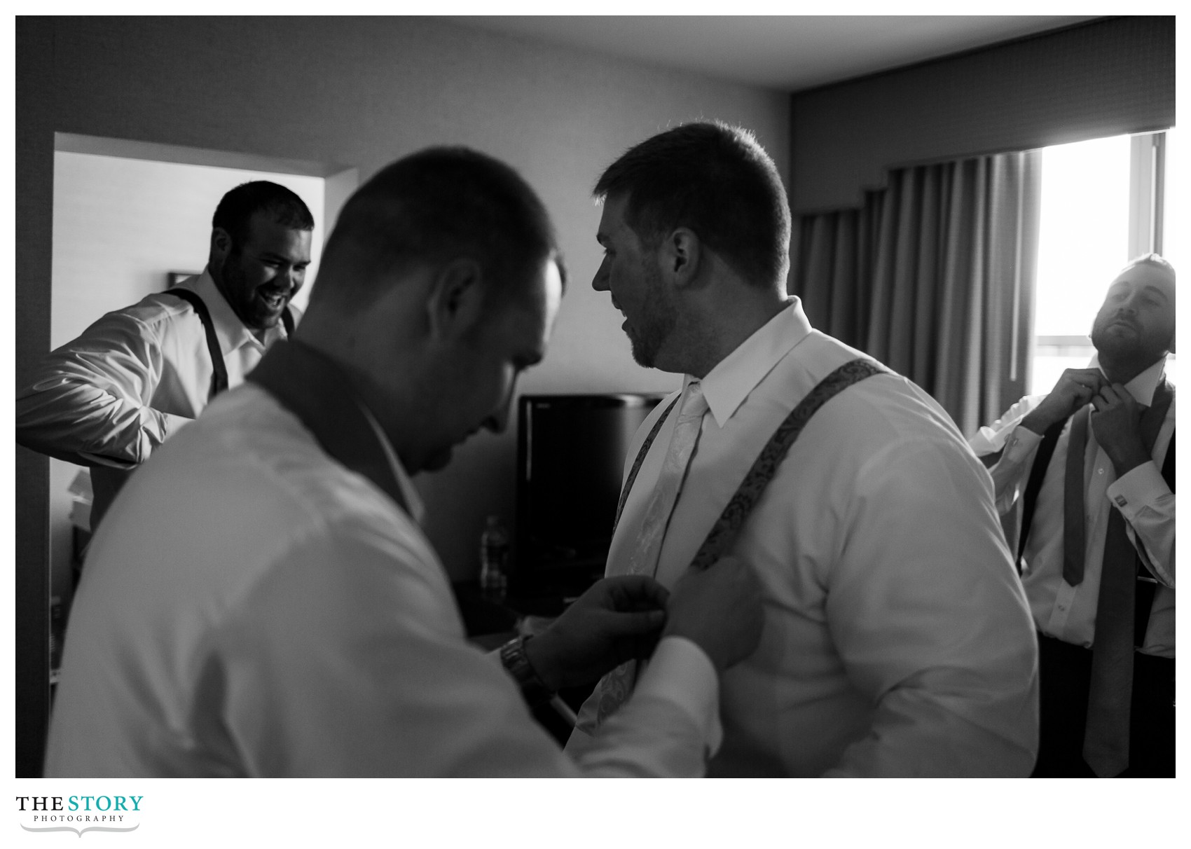 groom getting ready with groomsmen at Genesee Grande