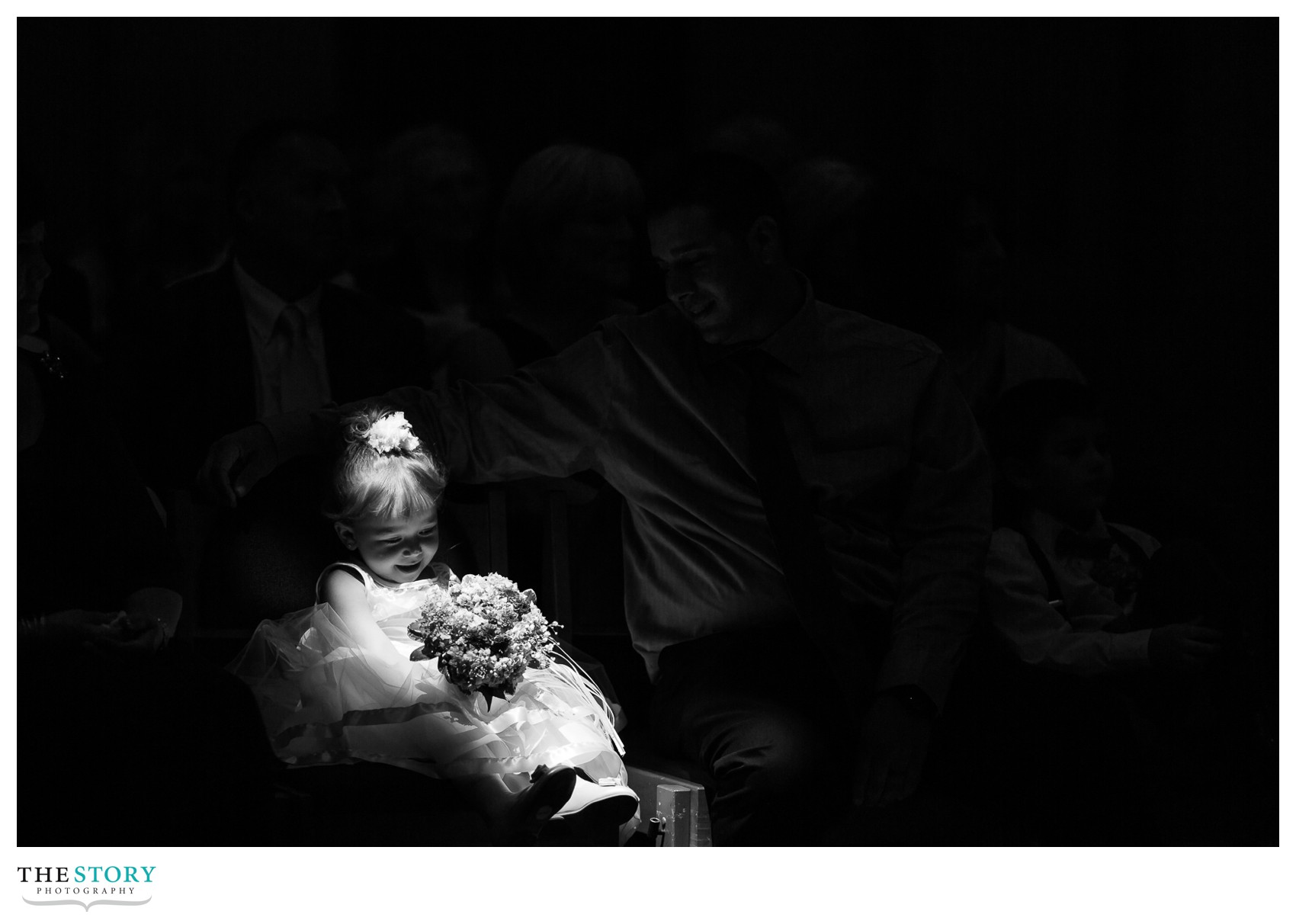 flower girl sitting in the light at LeMoyne College Chapel