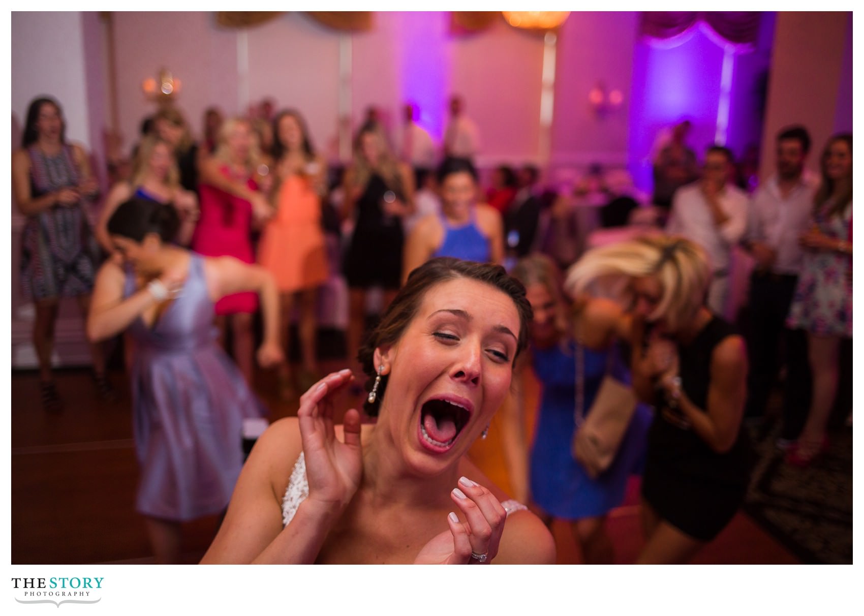 bride's reaction after her bouquet toss at Genesee Grande