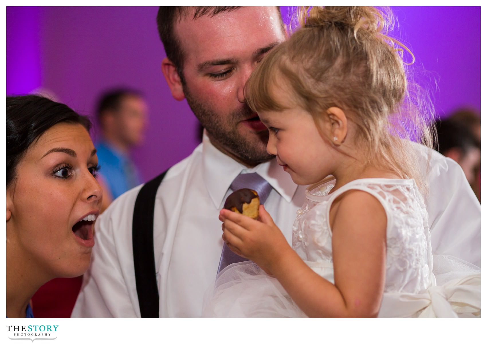 candid moment with flower girl at wedding reception