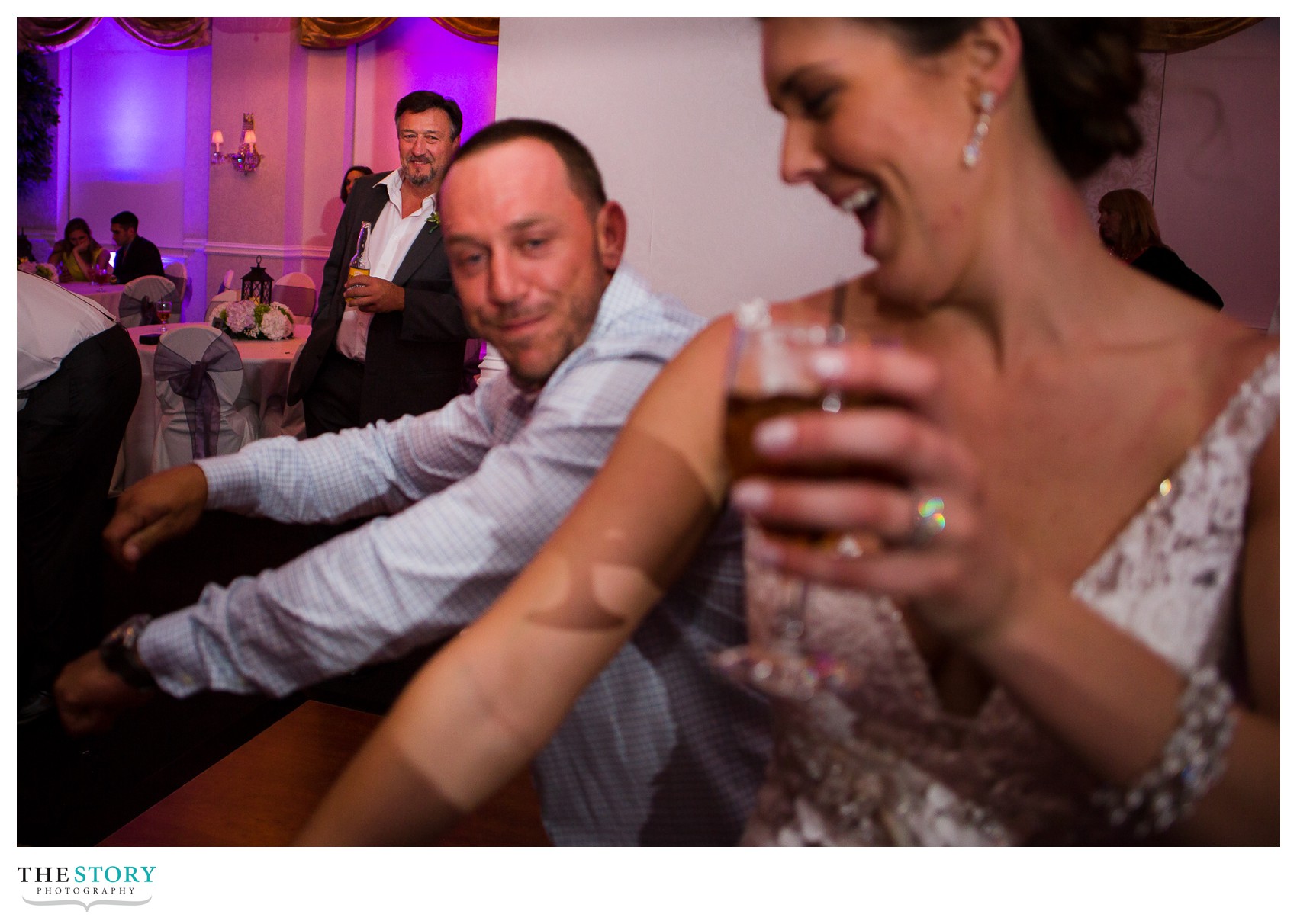 father looking on at bride dancing during wedding reception