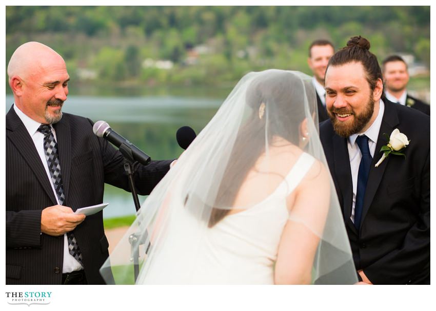 bride and goom exchange vows at lakeside wedding in Cooperstown