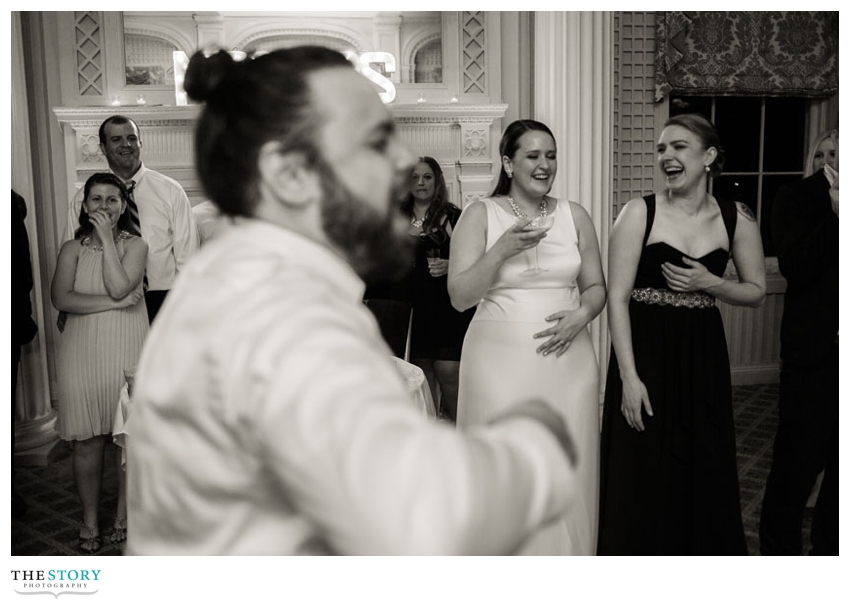 bride's reaction to groom's dancing at wedding reception