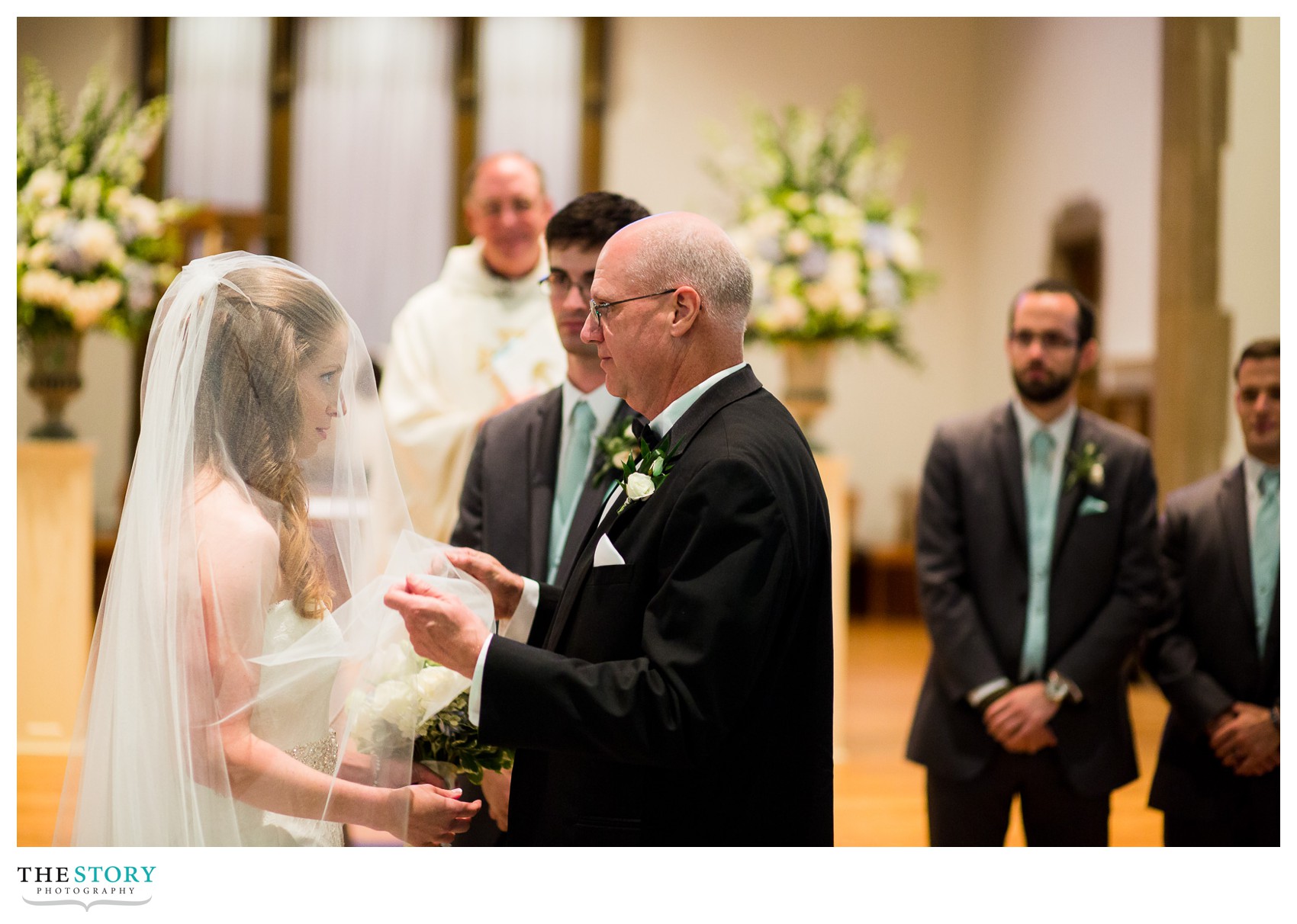 father lifting bride's veil at Nazareth College wedding
