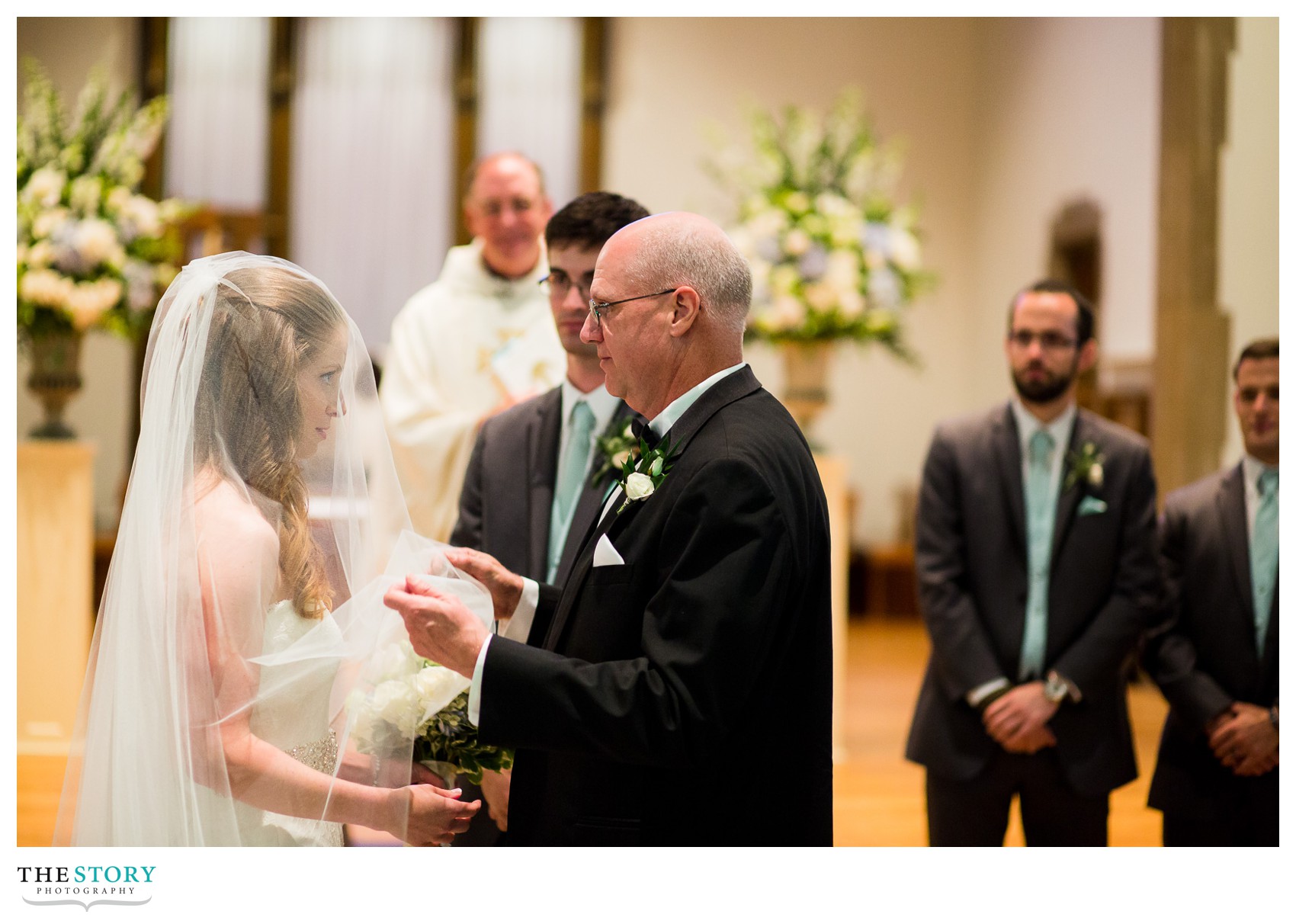 father lifting bride's veil at Nazareth College wedding