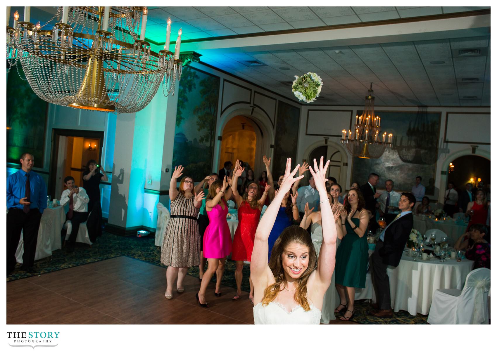 bride throwing bouquet at Inn on Broadway wedding reception