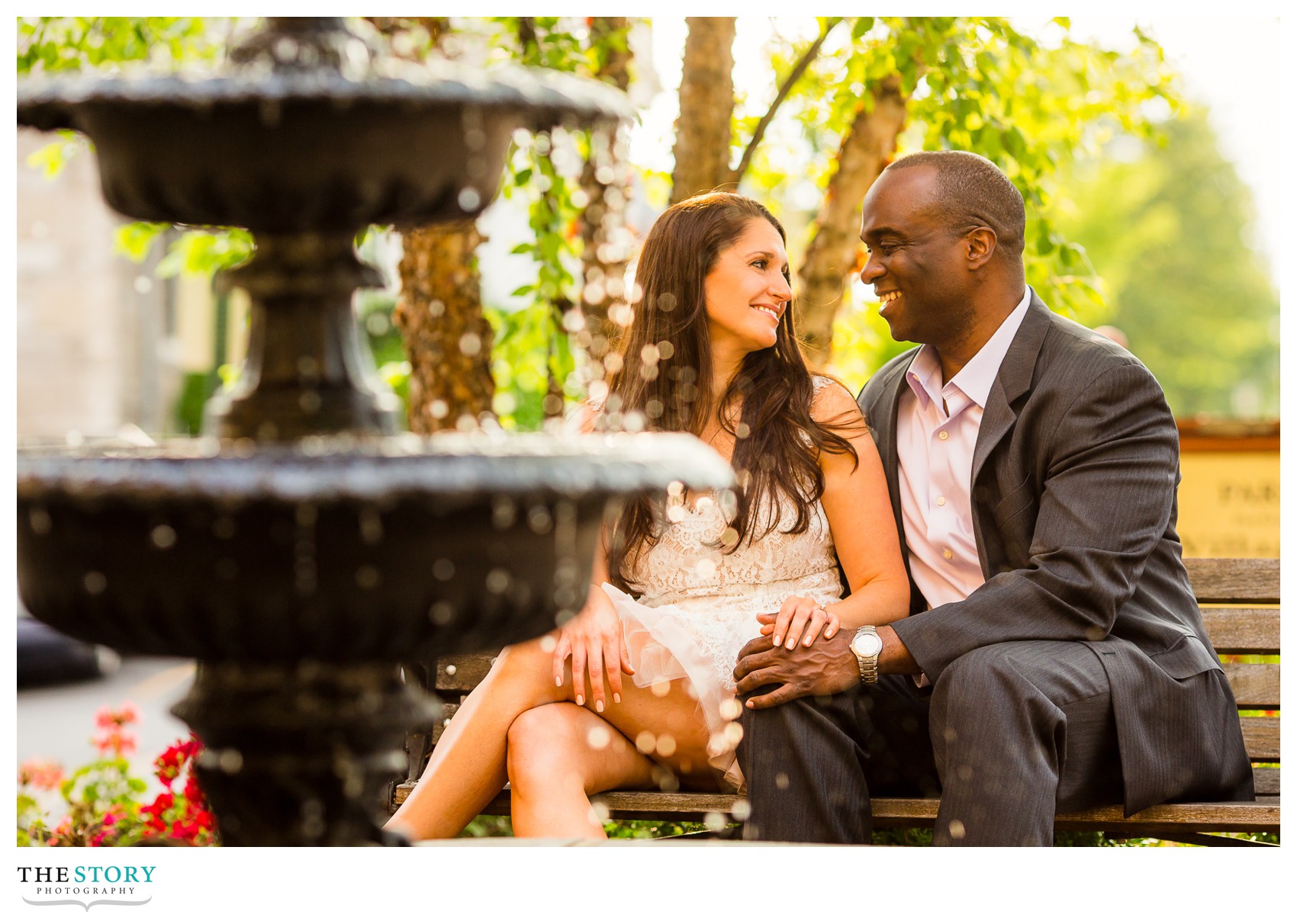 couple sitting on bench near fountain in Skaneateles, NY