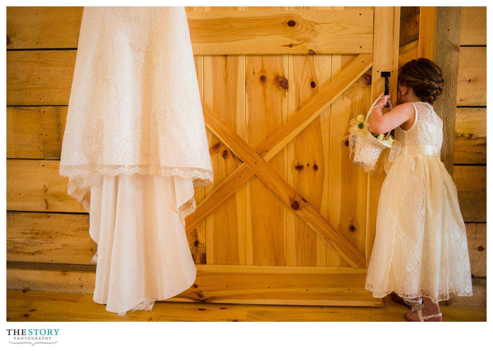 flower girl peeking in on bride getting ready for Wolf Oak Acres wedding