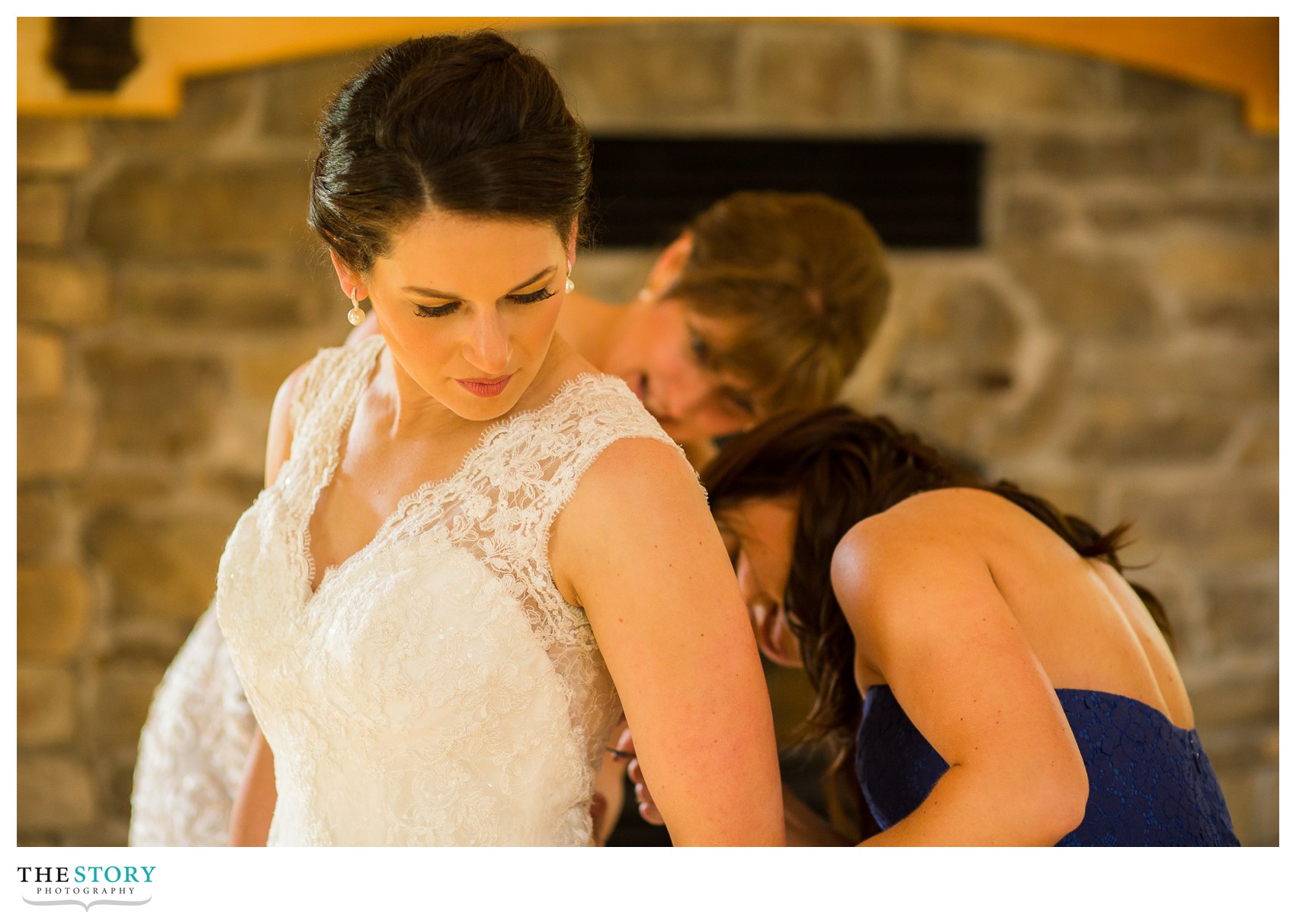 bride getting dress on in Wolf Oak Acres barn