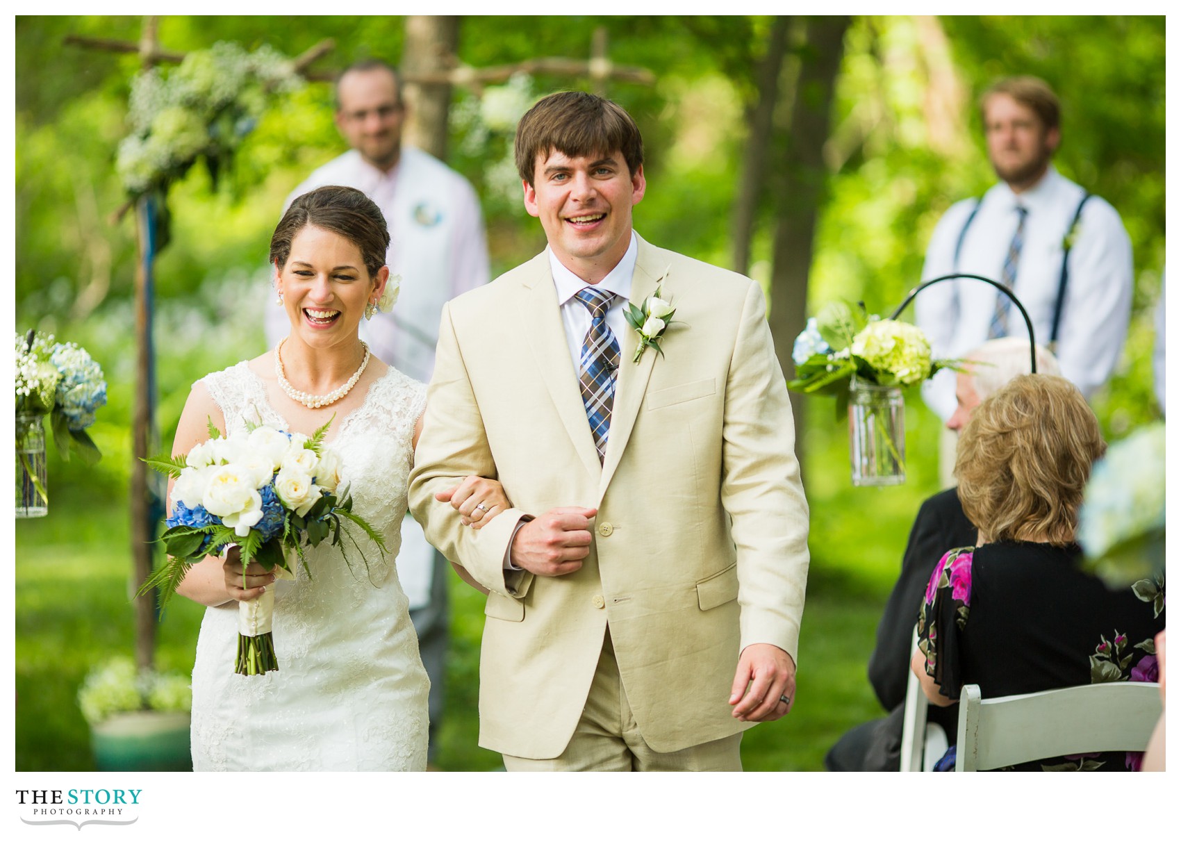 bride and groom leaving outdoor wedding ceremony at Wolf Oak Acres