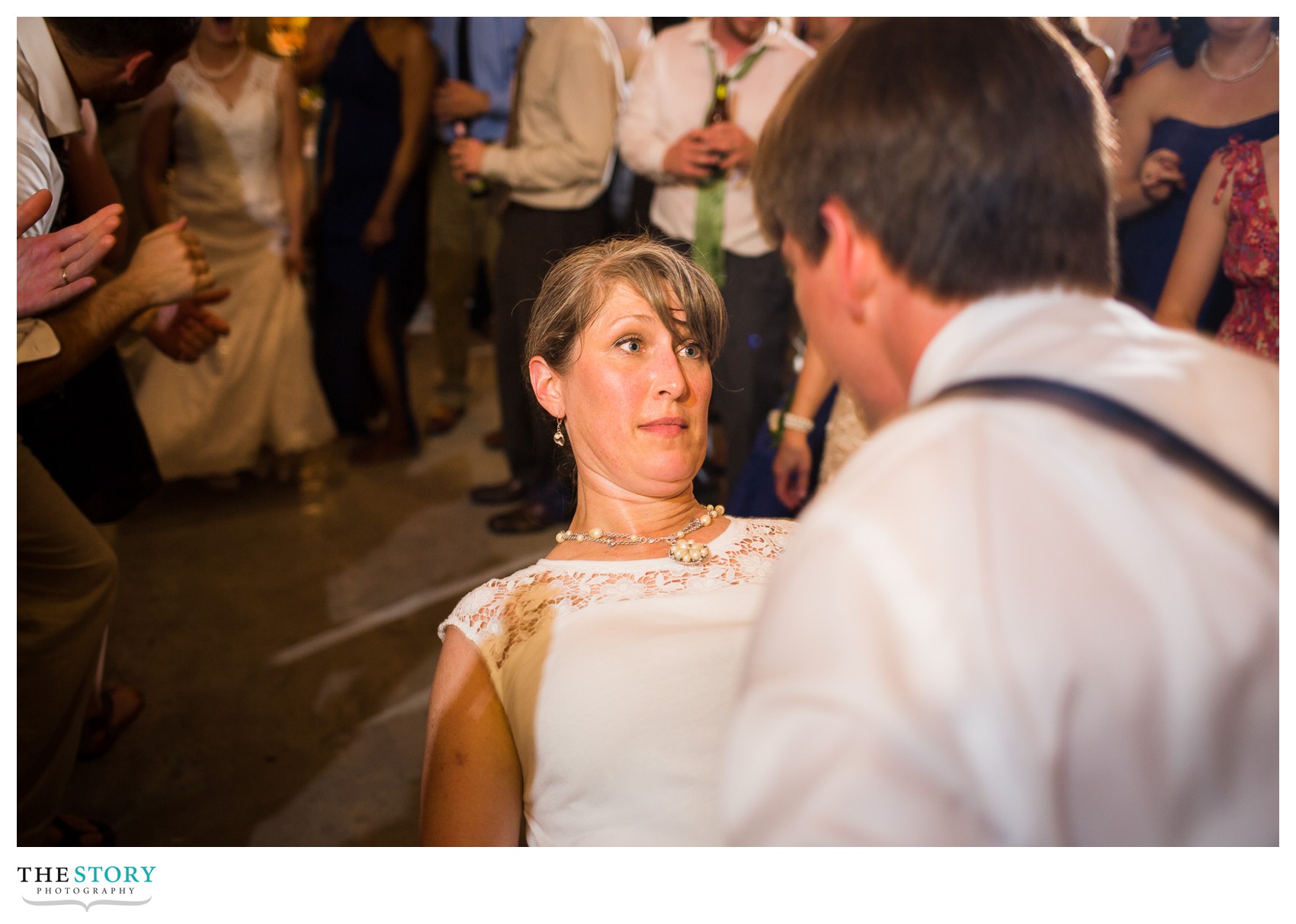 wedding guest dancing with groom at Wolf Oak Acres