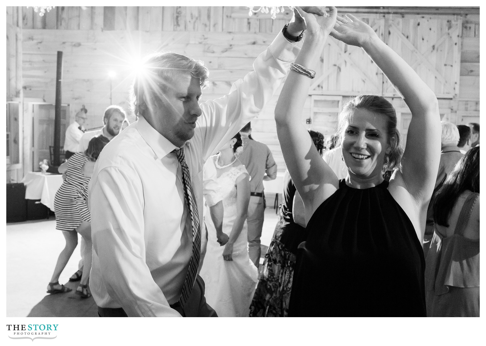 wedding guests dance at Wolf Oak Acres barn wedding