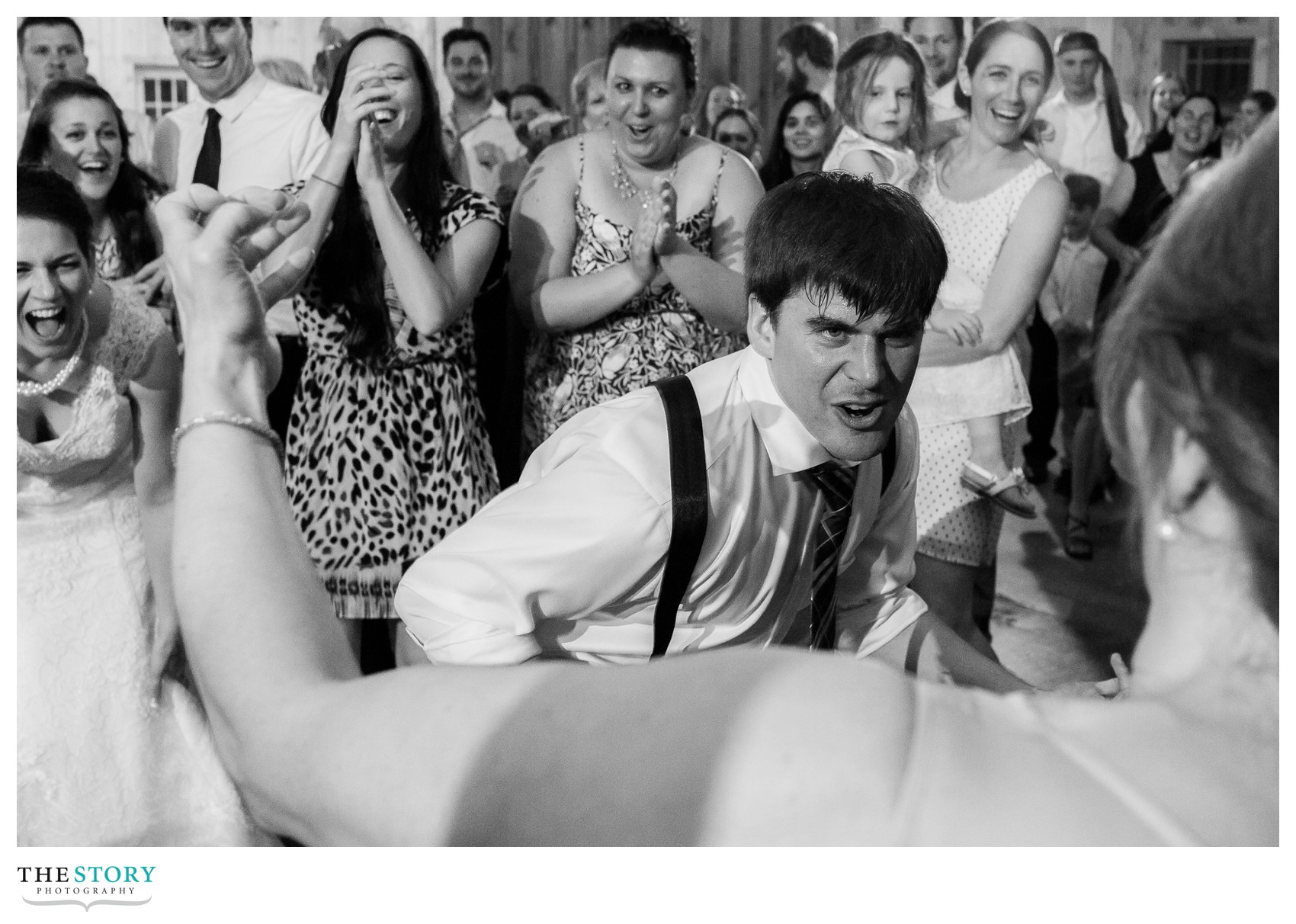 groom in air guitar battle at upstate, ny barn wedding 