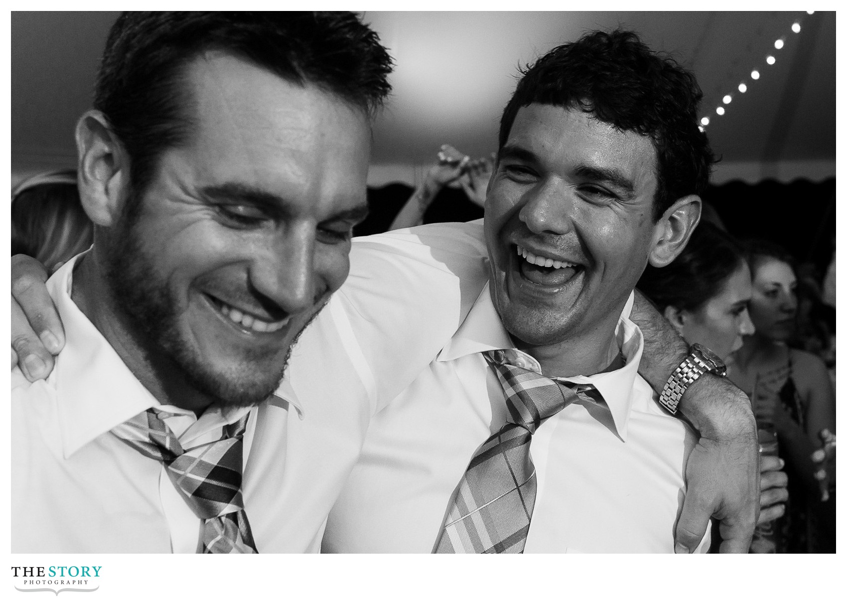 groom laughing at wedding reception in cazenovia