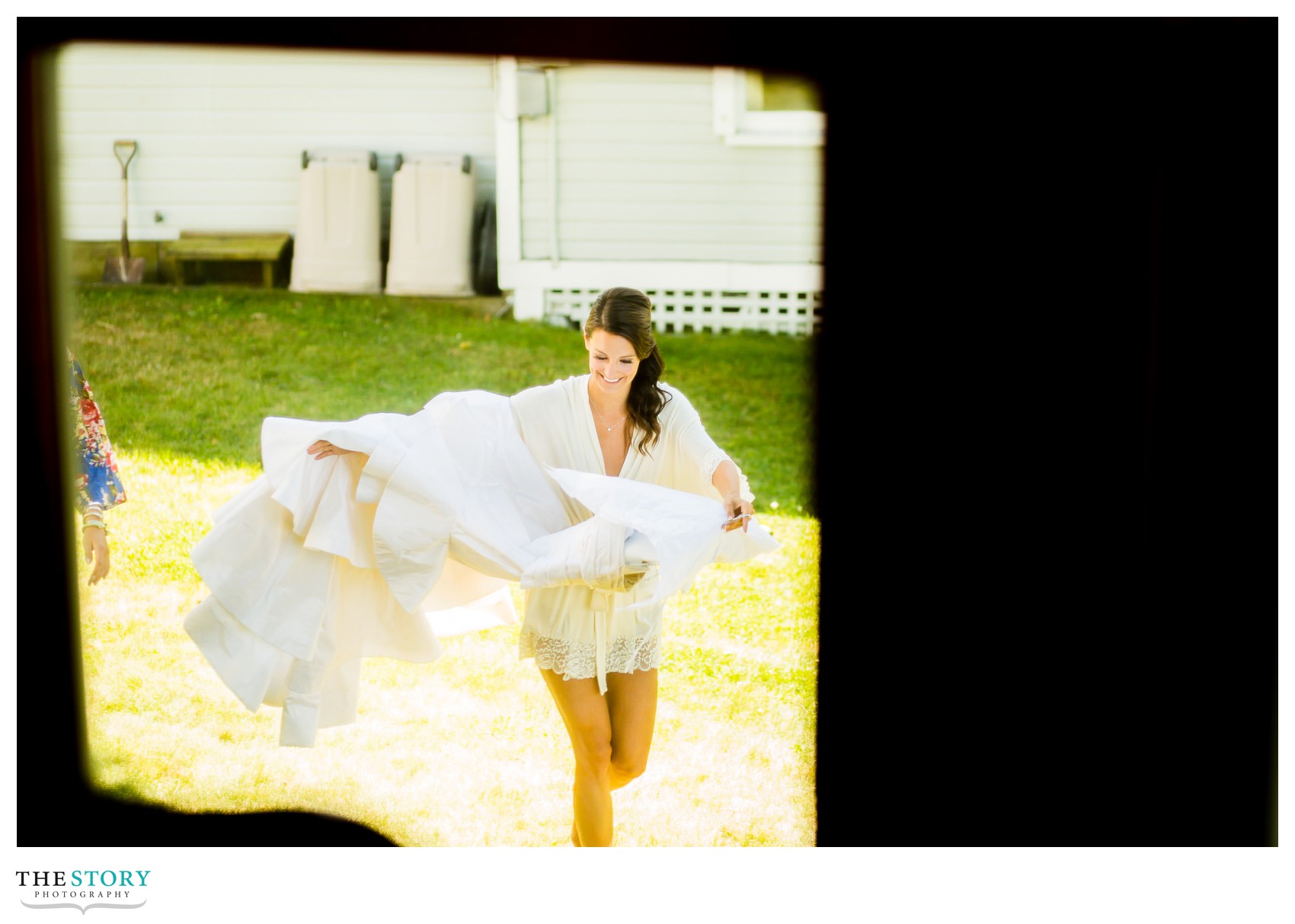 bride carrying wedding dress on wedding day