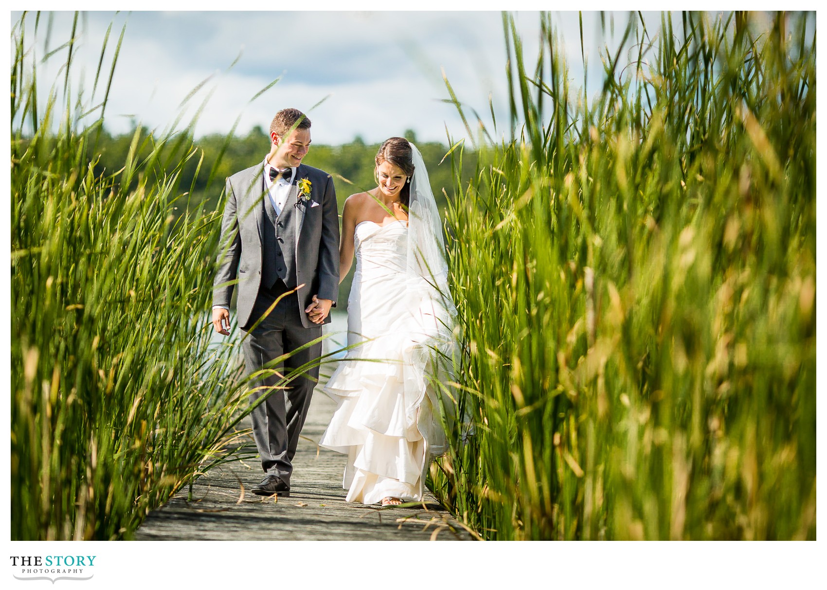 bride and groom walk dock on Wellesley Island