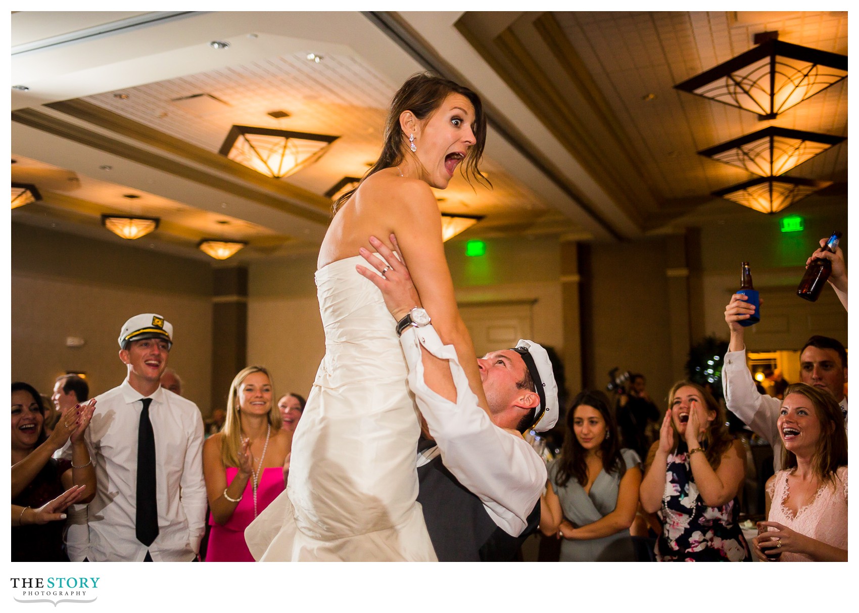 groom lifts bride in the air