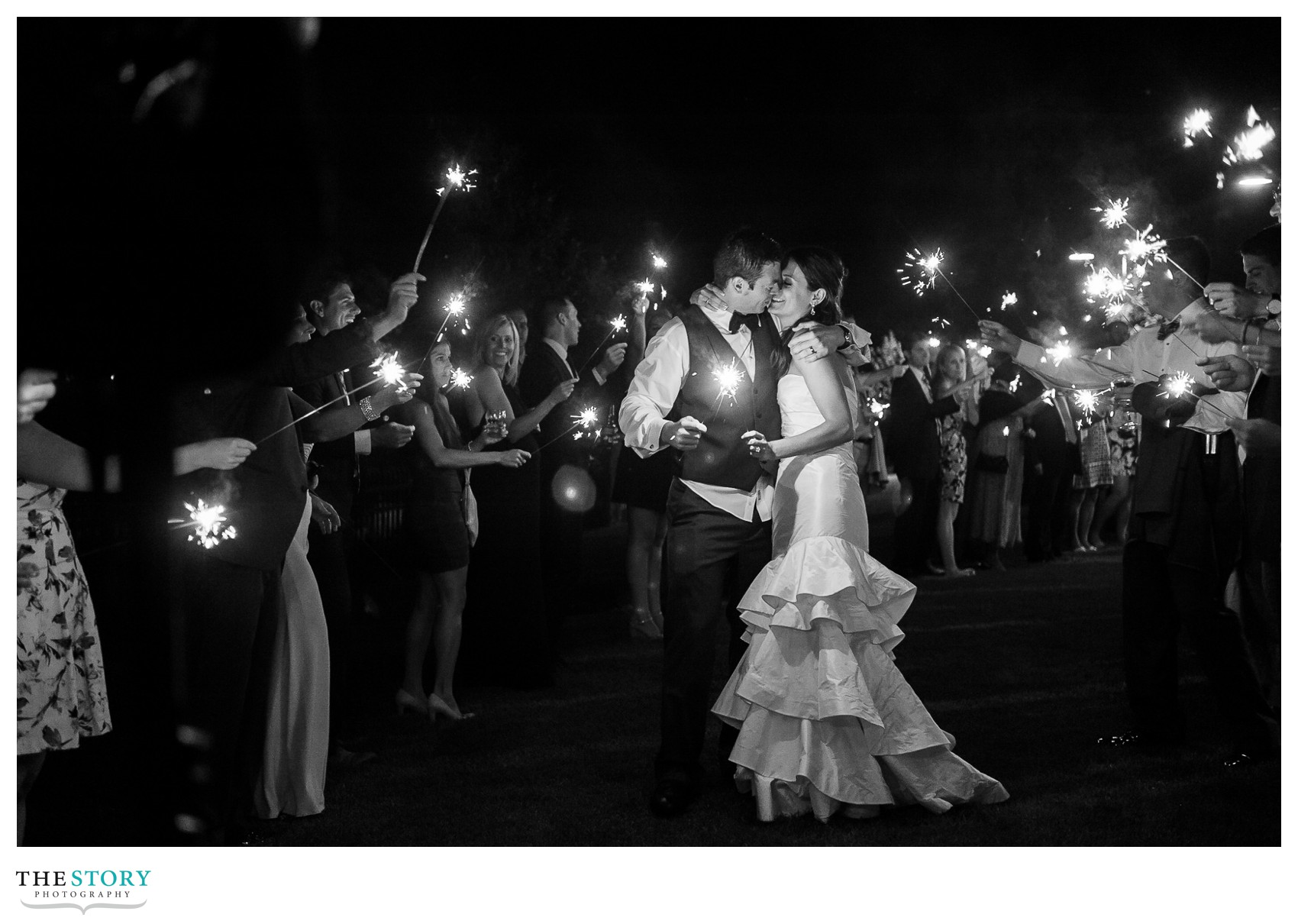 bride and groom finish out the wedding day with their guests and sparklers