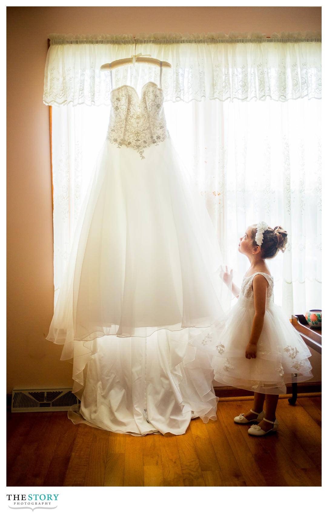 flower girl admiring the bride's dress on the wedding day