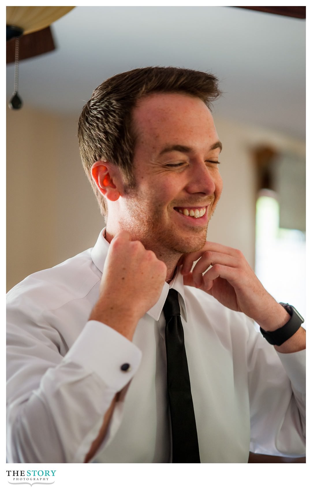 groom getting ready at home on wedding day