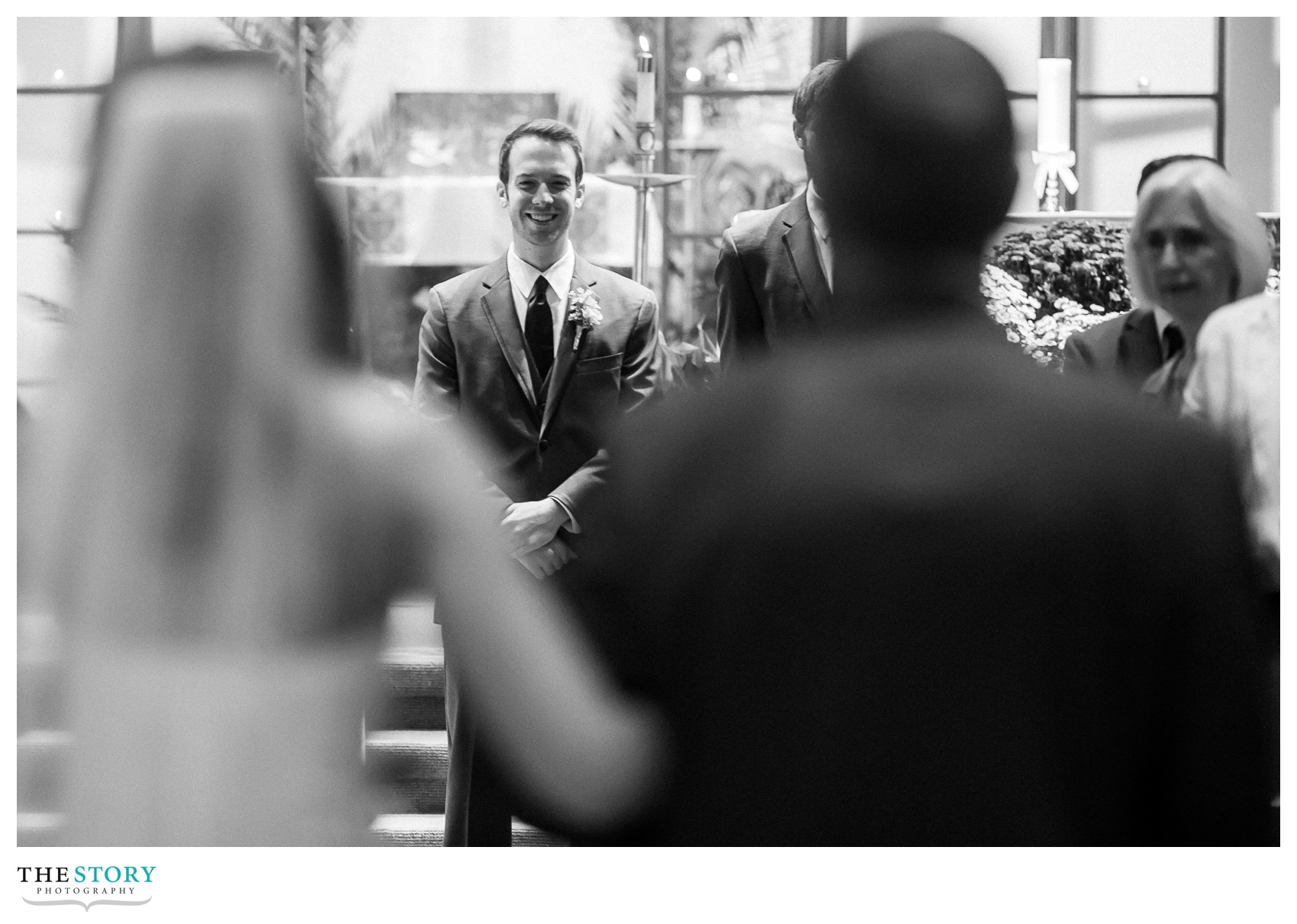 groom watching bride walk down the aisle at St. Ann's church wedding