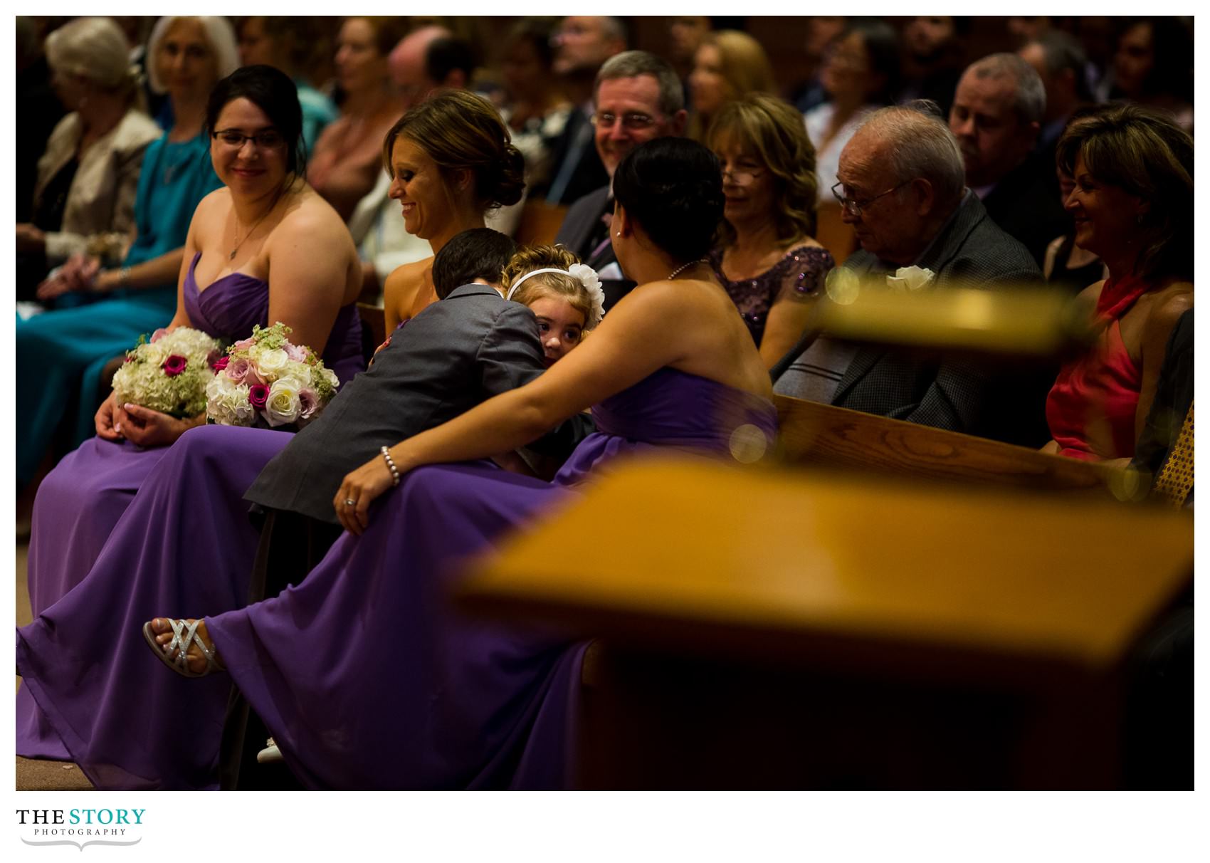 ring bearer give flower girl a hug during wedding ceremony