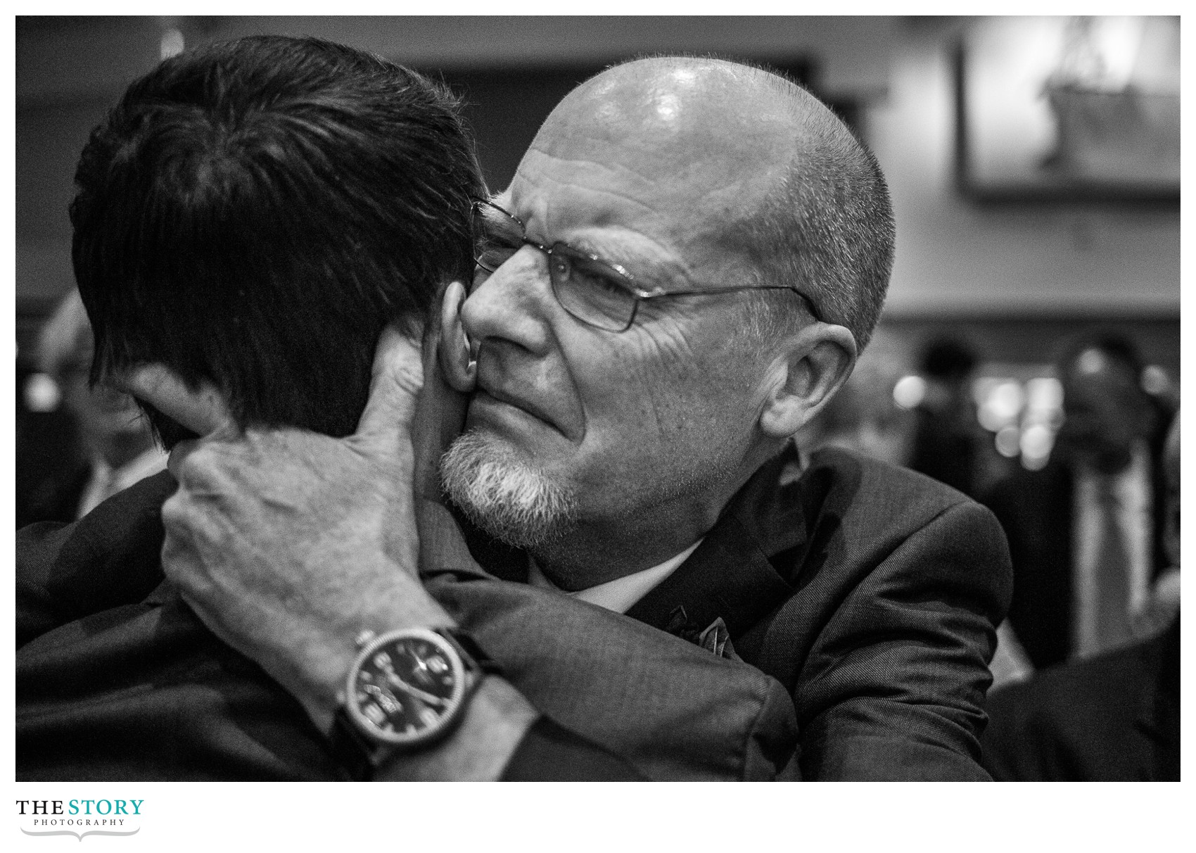 groom's father gives a hug during the wedding ceremony in Manlius, NY