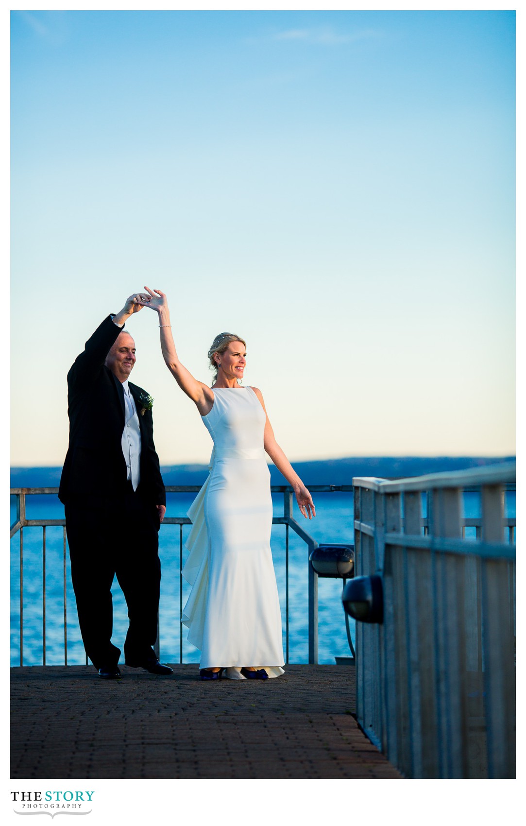 wedding photos of bride and groom dancing on the pier in Skaneateles