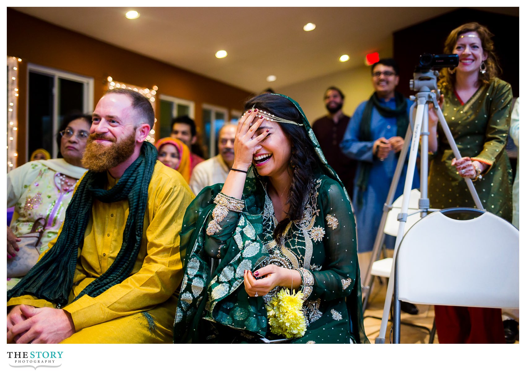 bride's reaction to groom dancing at henna celebration