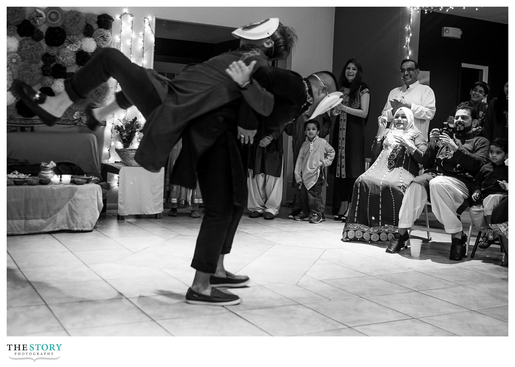 groom's friends dancing for henna celebration guests