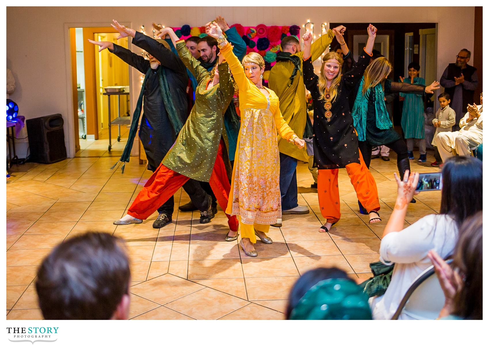 groom's family finishes their choreographed dance at henna celebration