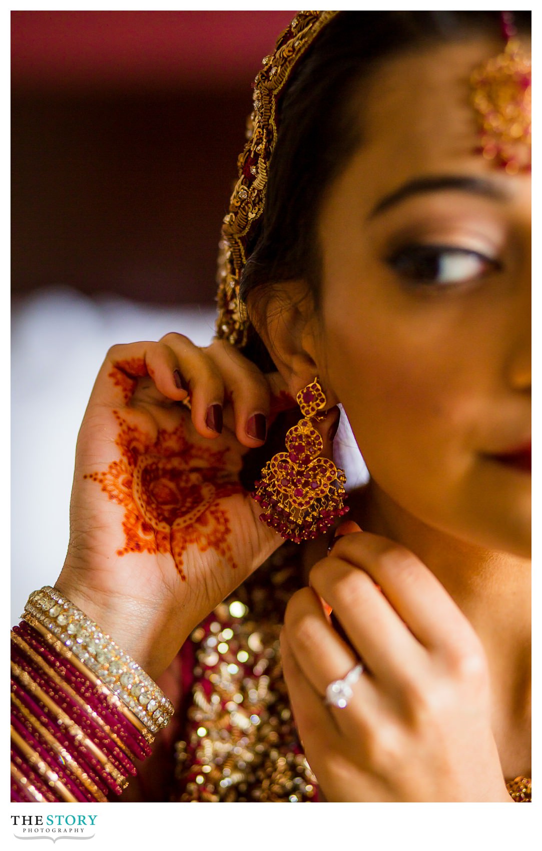 bride's henna and earring as she gets ready for Rochester Riverside Radisson wedding day