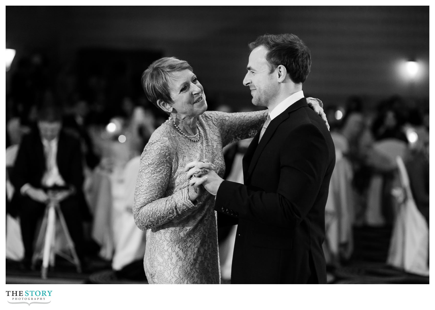 groom dances with mother at Rochester Riverside Radisson wedding reception