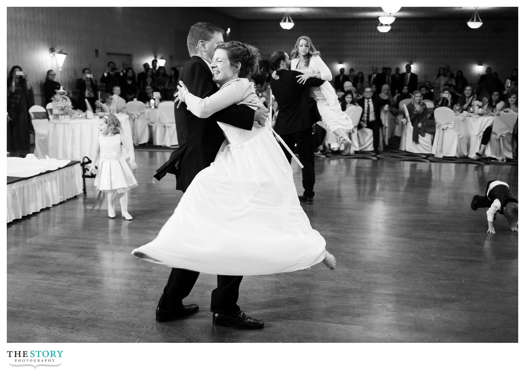 groom's family performs dance for wedding guests at Rochester Radisson reception