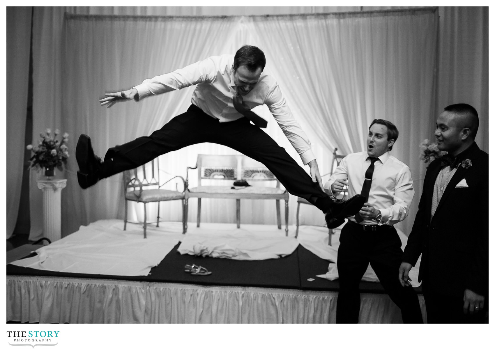 groom jumps off stage at Rochester wedding reception