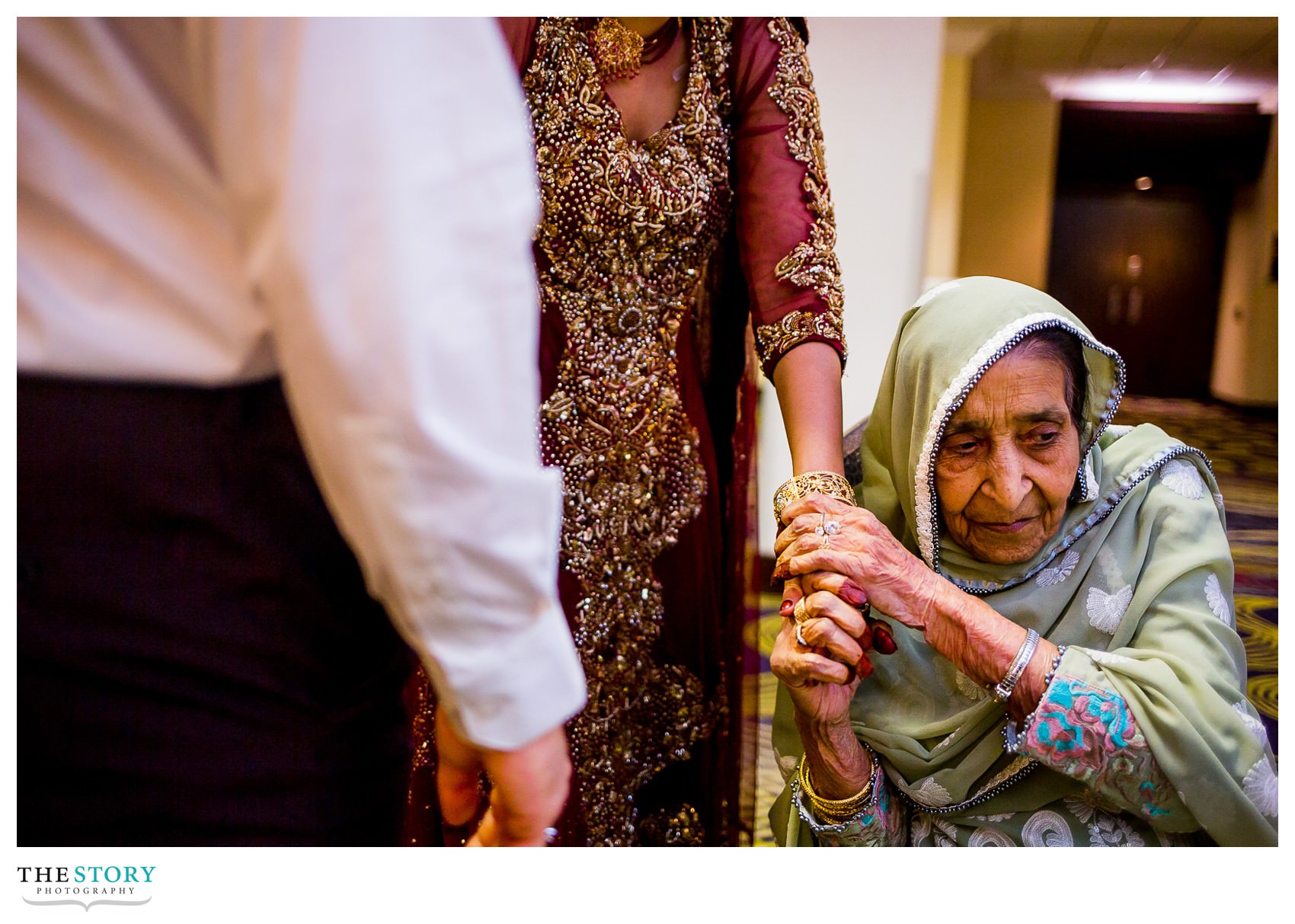 bride's grandmother holds her hand