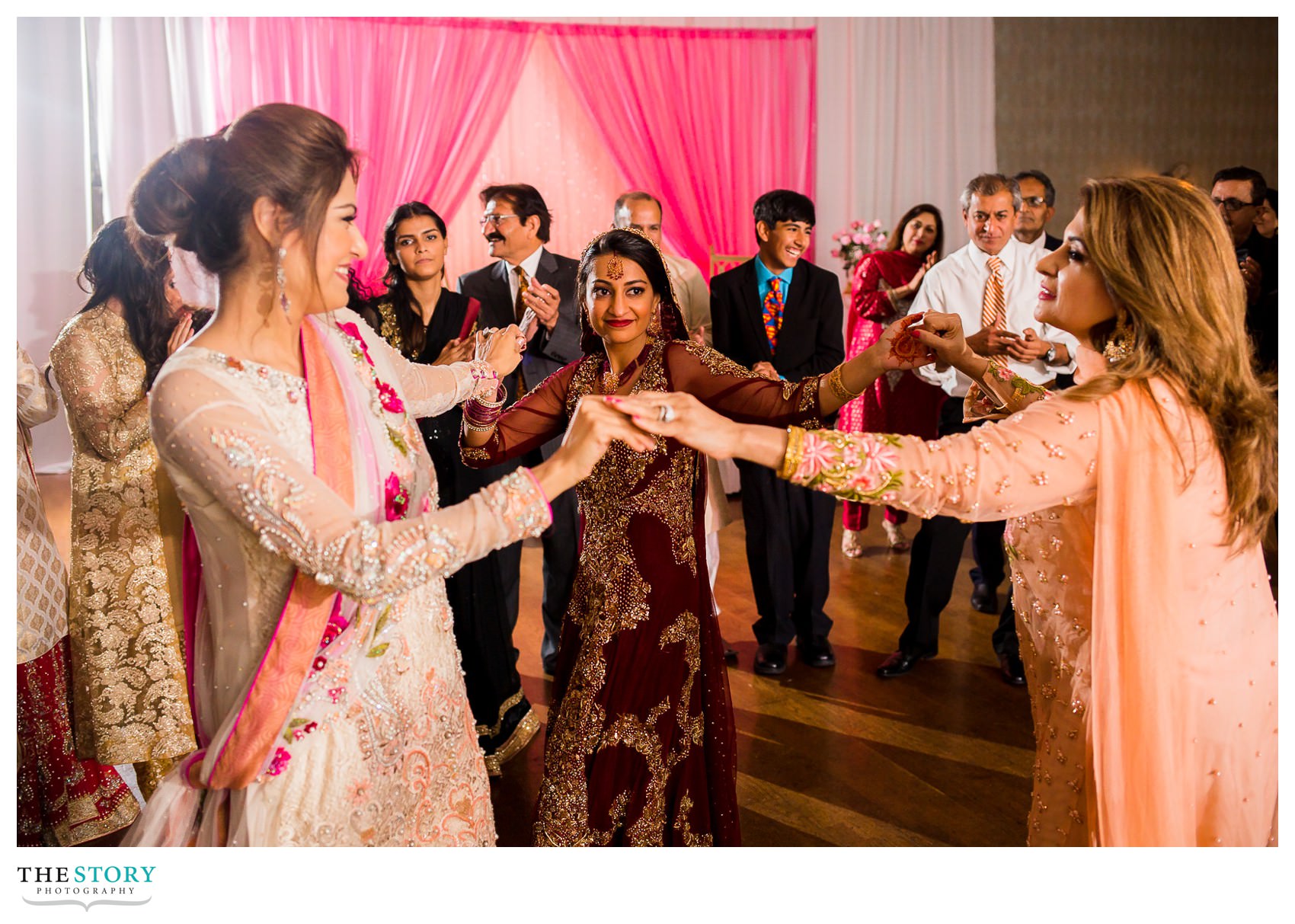 bride dancing with wedding guests at reception