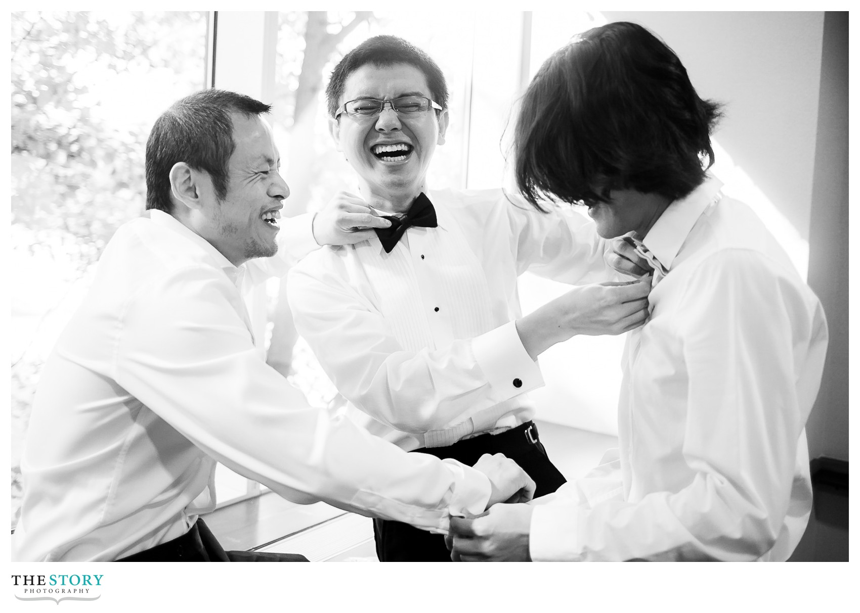 groom and groomsmen helping each other get ready at Cornell's Statler Hotel
