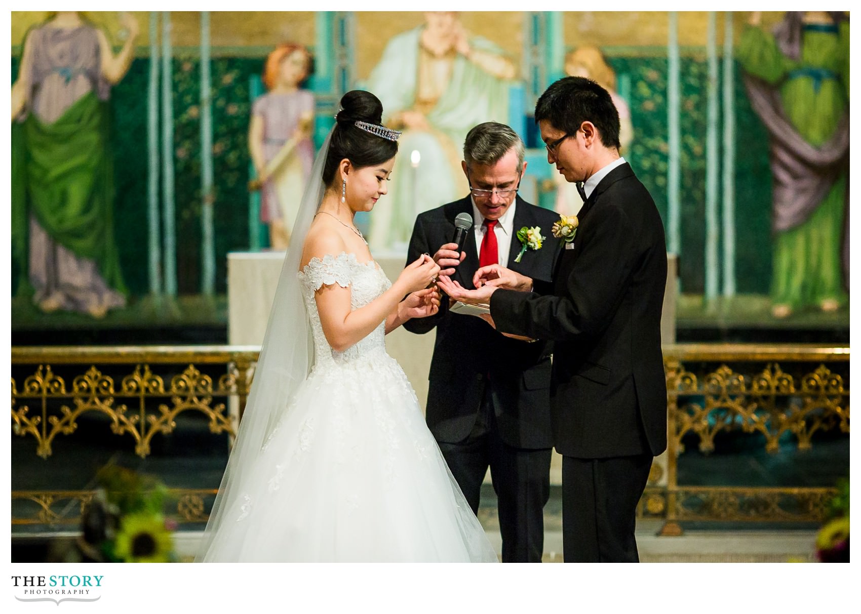 bride and groom exchange rings at Sage Chapel wedding