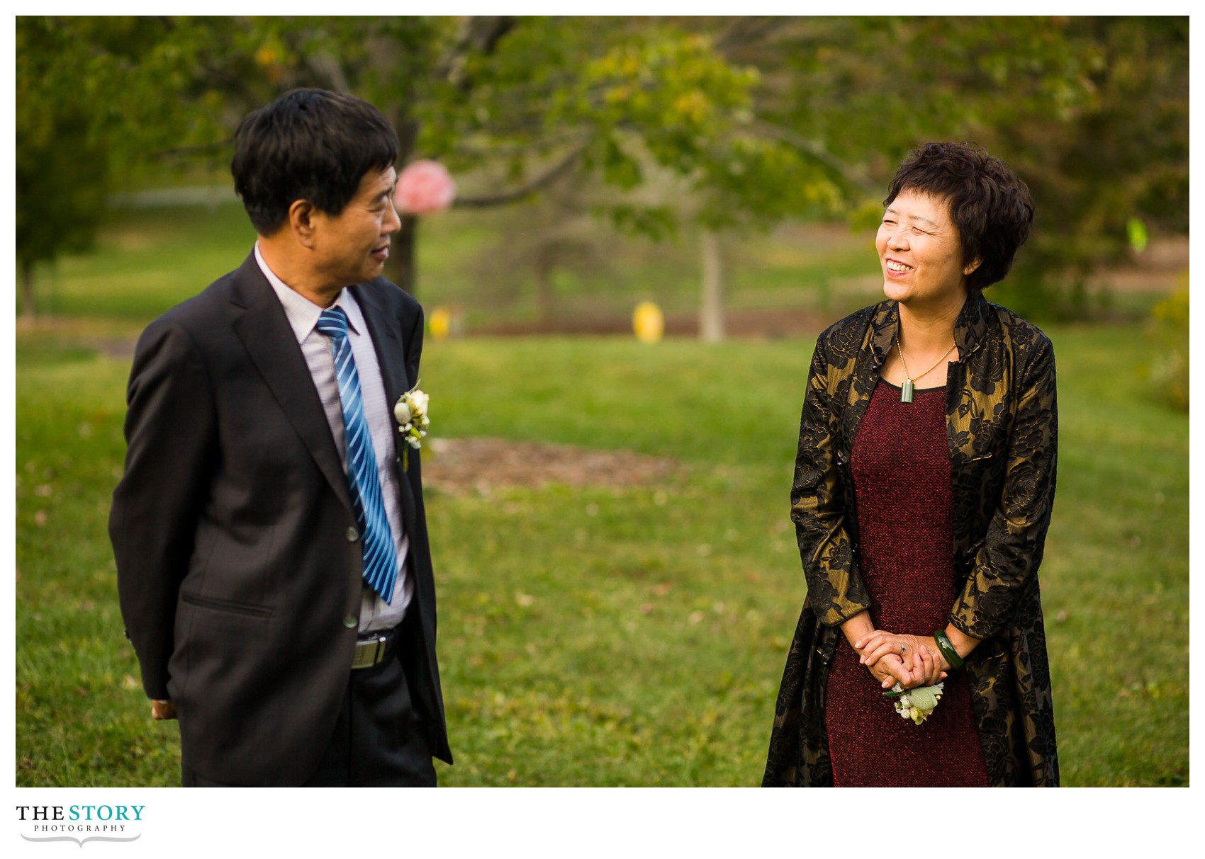 bride's parents share a moment during speeches at Cornell wedding