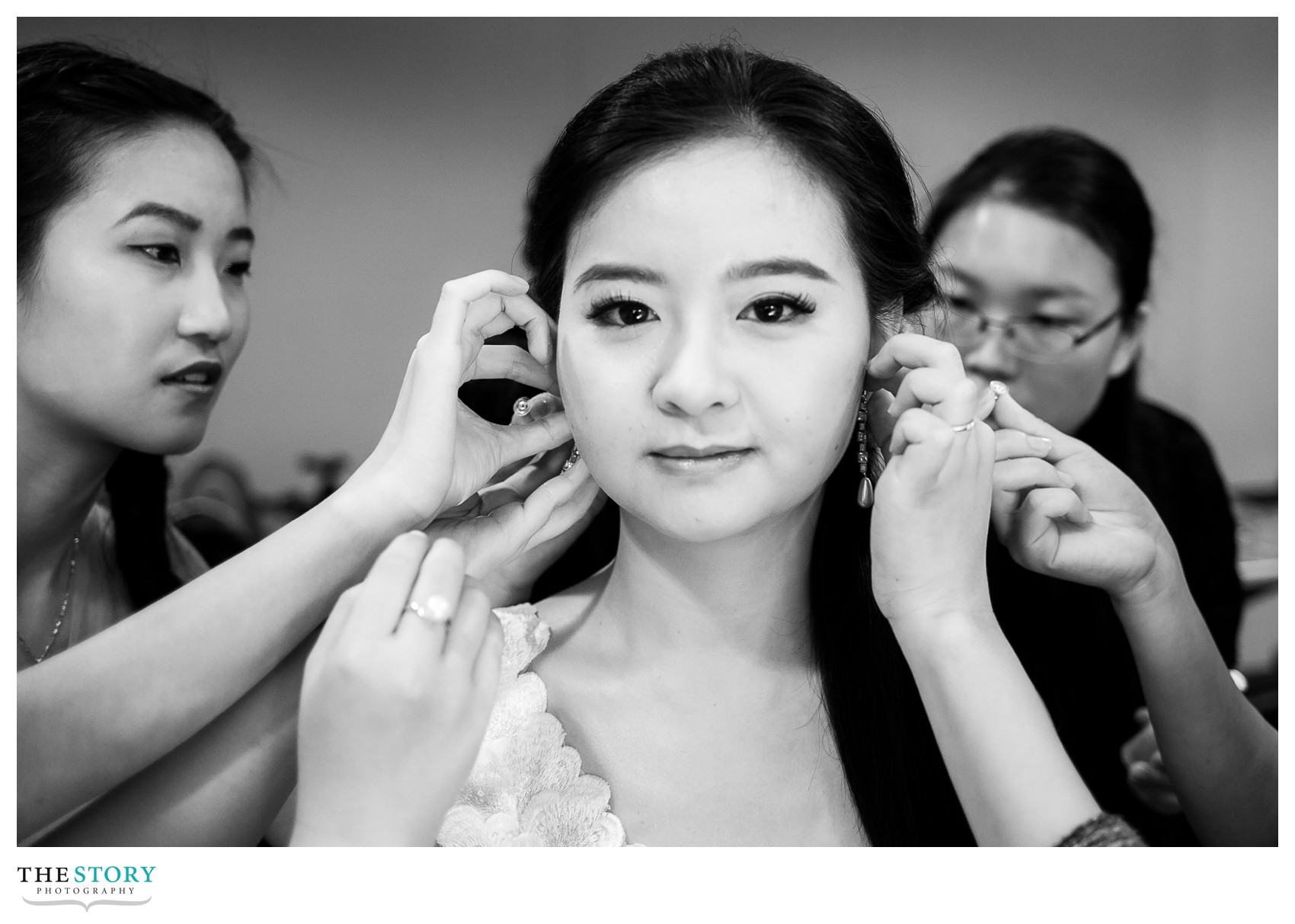 bridesmaids helping bride get ready for Cornell University wedding