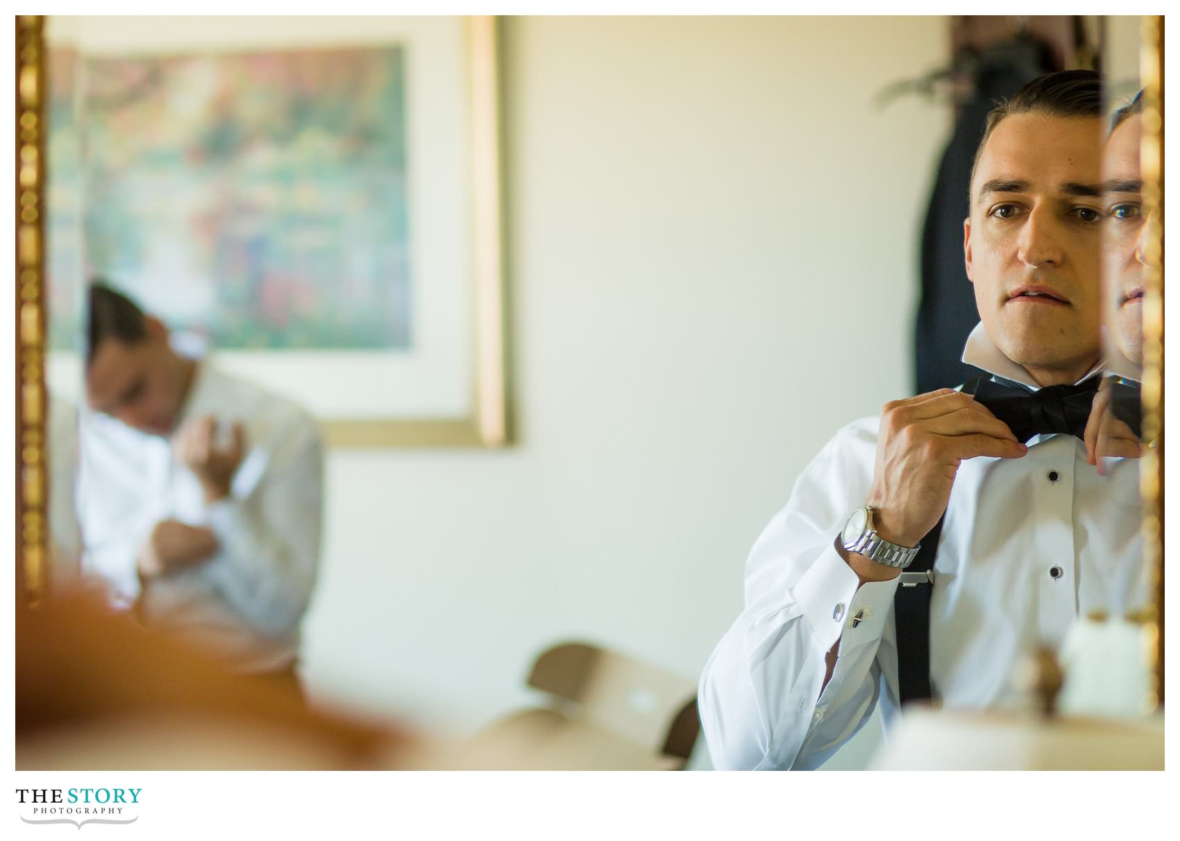 groom getting ready at Genesee Grande Hotel